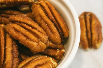 Pecan nuts in white bow close up