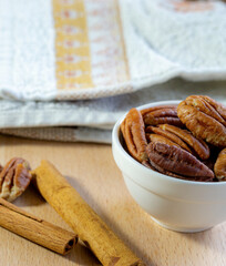 Pecan nuts and cinnamon sticks close up