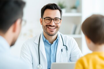 Fototapeta premium Smiling pediatrician interacts with young patient in a bright clinic setting during a routine checkup