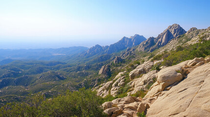 Naklejka premium Majestic mountain range under clear blue sky with lush greenery and rocky peaks