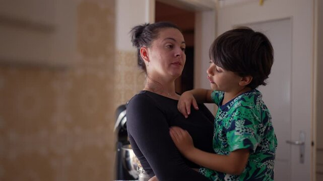 Mother addressing young boy&rsquo;s misbehavior as he pretends to hit her face, emphasizing parenting struggles, teaching moments, and addressing childhood aggression in home setting