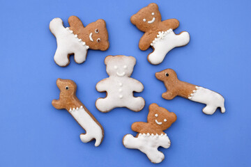 Cute gingerbread bears and dachshunds on a blue background 