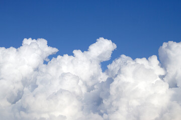 Fluffy Cumulus Clouds in summer sky