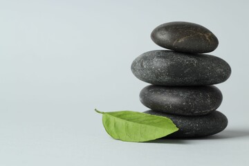 Fototapeta premium Stack of rocks on gray background, space for text. Harmony and life balance