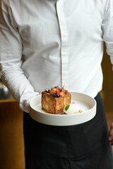 A plate of French toast topped with fresh berries and a glass of champagne. A delicious breakfast or brunch dish