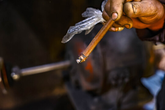 Moroccan craftsman smoking kiff with a sebsi in Marrakesh, morocco