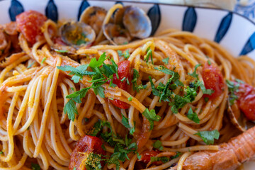 Spaghetti fruti di mare with seafood on the beach of Sardinia Italy