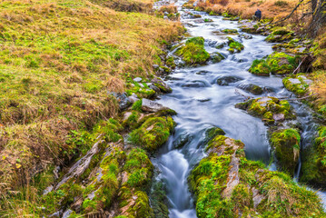 autumnal mountain landscape with a small stream  inside the Alpe Devero, Val D'Ossola, Verbania, Italia	
