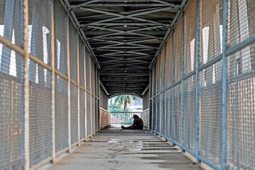 Homeless people sleeping on footbridges