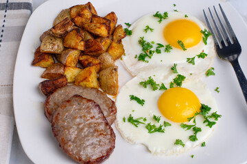 fried eggs top with parsley  with sausage patty