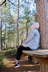 Fototapeta premium treehouse retreat. Woman sitting outdoors. High quality photo