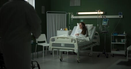 Doctor enters the room with a tablet, ready to review the patient's progress.