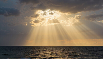 Sunbeam breaking through stormy clouds over calm ocean, hope and serenity