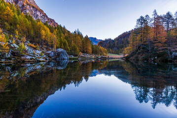 autumnal mountain landscape with a small lake inside the Alpe Devero, Val D'Ossola, Verbania, Italia	