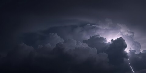 Dark grey sky with thick, billowy clouds and lightning illuminating the clouds in bright white, darkening sky, northern illinois, lightning flash