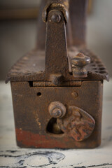 Rusty Vintage Iron with Wooden Handle Sitting on a Table