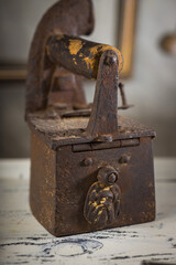 Rusty Vintage Iron with Wooden Handle Sitting on a Table