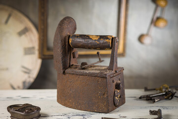 Rusty Vintage Iron with Wooden Handle Sitting on a Table