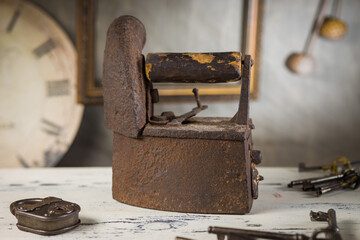 Rusty Vintage Iron with Wooden Handle Sitting on a Table