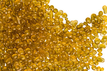 Amber-colored bone glue beads on a white background
