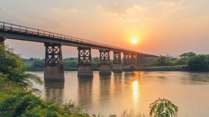 Fototapeta premium Tranquil Sunset Over River with Silhouetted Bridge