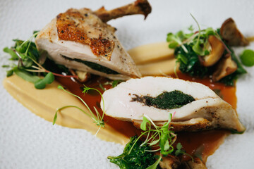 Indulge in our Gourmet Stuffed Chicken Breast, perfectly paired with a flavorful Herb Sauce