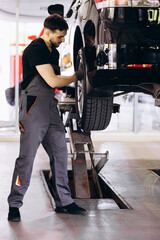 Car mechanic at car service checking up the car