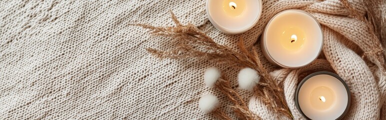 Cozy minimalist mockup background with space for text featuring warm neutral tones, soft knitted fabric, and candles, perfect for autumn, winter, or home decor themes