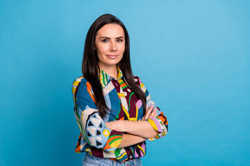 Portrait of confident serious girl with straight hairdo dressed print blouse holding arms crossed...