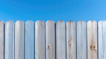 Fototapeta premium Wooden fence against blue sky; background for design