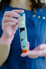 Doctor is demonstrating auto-injector syringe as an emergency treatment for allergic reaction