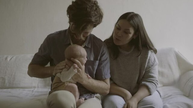 Help, mother and baby with father on sofa for happy, bonding and child care. Family, love and smile with parents and burping newborn infant in living room at home for peace, cute and happiness