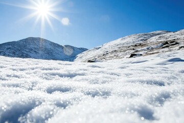 Snow coats the mountains, shimmering in sunlight and creating a tranquil winter wonderland rich in ice crystals