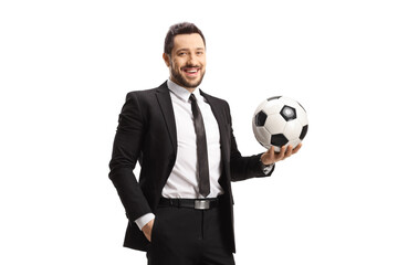 Football manager holding a ball and smiling