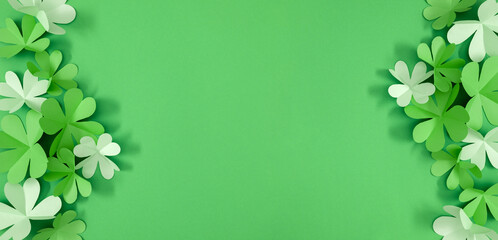 Four-leaf clover paper art. St Patrick's Day four leaf clover on green background. Patrick's Day composition. Top view Flat lay