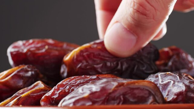 Fresh dates fruits close up on kitchen, close up in supermarket. Eating dried fruits. Vegan, vegetarian food. 