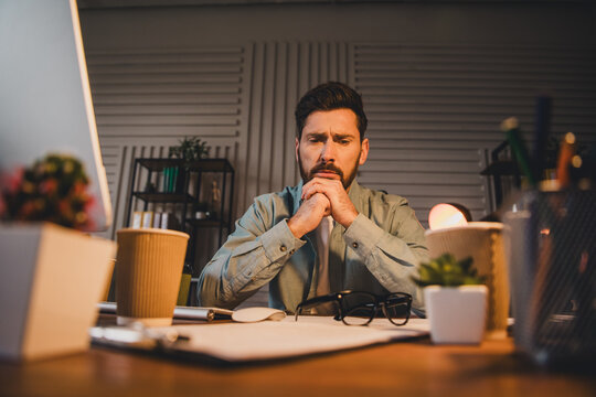 Focused man in casual attire working in a modern styled office interior