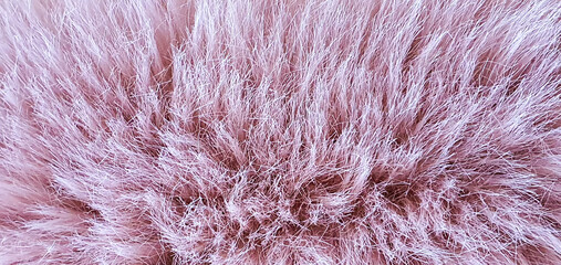 Soft and fluffy texture in a delicate pink hue, creating a cozy and inviting aesthetic perfect for home decor or fashion accessories.