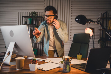 Young professional man multitasking at work in a stylish home office setting