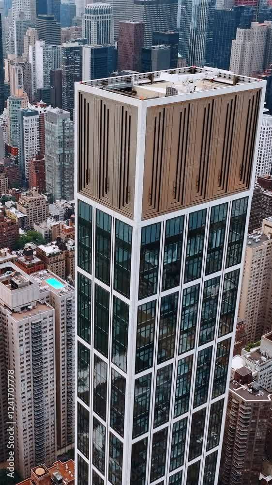 Wall mural Gorgeous skyscrapers overpeer above the city panorama. Breath-taking view of New York at daytime from top. Vertical video