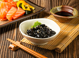Honey Black Beans served in bowl isolated on wooden background side view of taiwan food