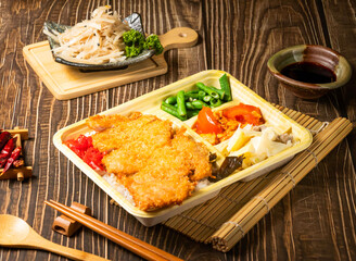 Jili Fried Pork Chop Bento with salad served in bowl isolated on wooden background side view of taiwan food