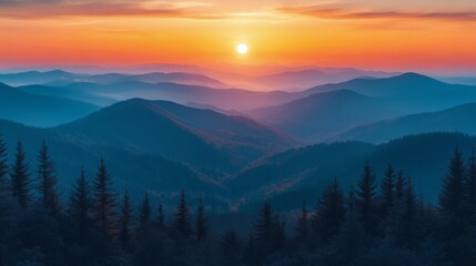 Obraz premium Breathtaking sunset over mountain range with misty valleys and silhouetted trees