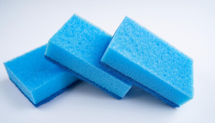 Blue kitchen sponges for dishwashing on white background. Foam scrubber. Dish cleaning sponge.