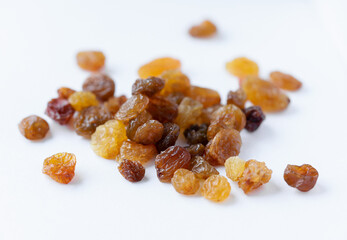 A bunch of tasty and appetizing raisins of yellow and brown color, on a light background. Natural and healthy sweets