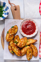 Baked potatoes in country style with ketchup.style rustic.selective focus