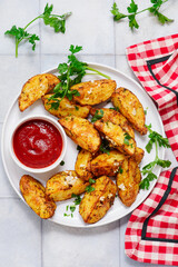 Baked potatoes in country style with ketchup.style rustic.selective focus