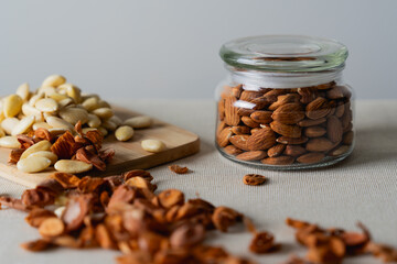 Whole almonds in glass jar and on cutting board