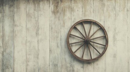 Rustic wooden wagon wheel on weathered wall