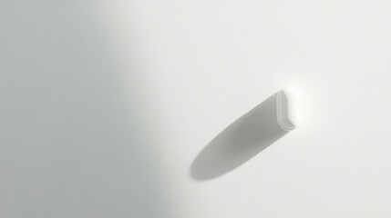 Single white pill resting on a clean white background with soft shadows in a minimalist style